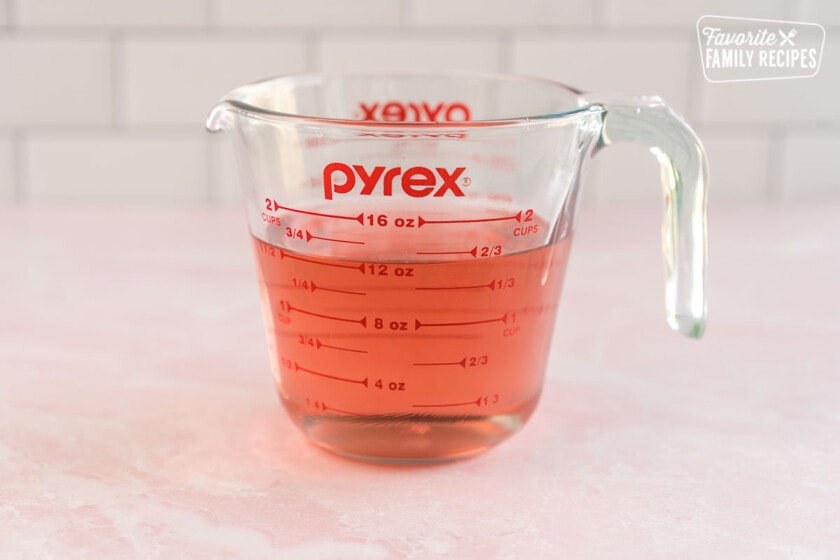 Vinegar, sugar, and salt in a glass measuring cup