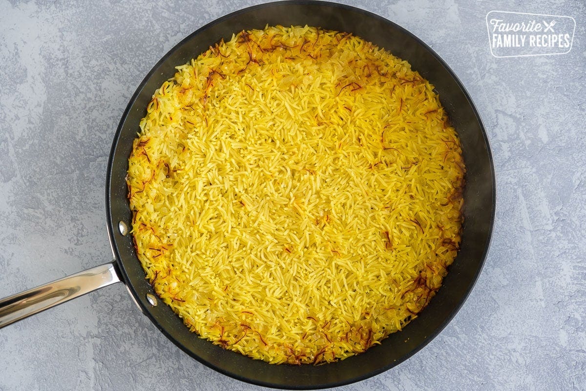 A large skillet filled with saffron rice