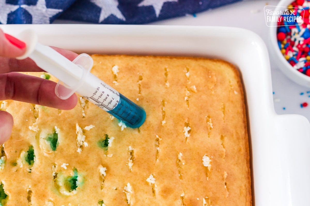 Injecting blue jello into 4th of July Cake.