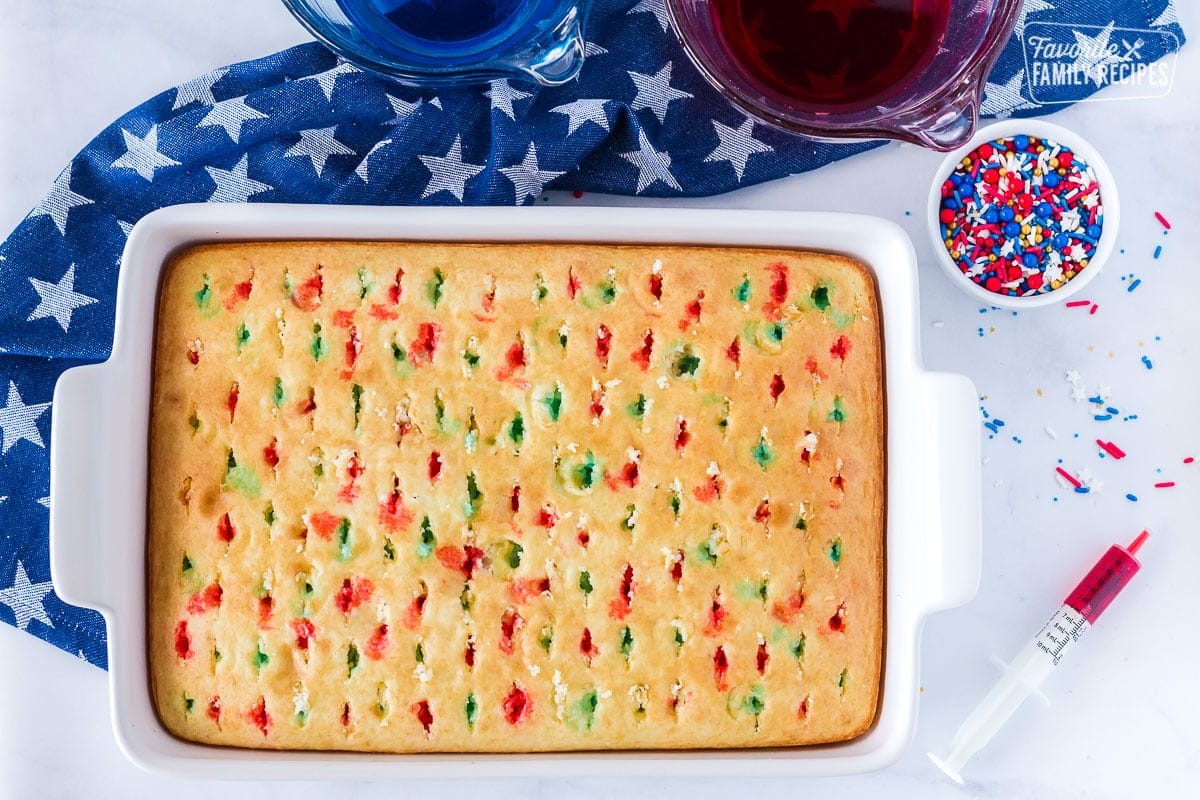 Unfrosted 4th of July Cake with jello in the holes.