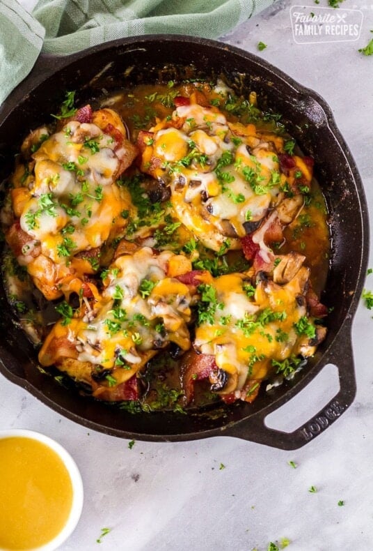 Four pieces of Alice Springs Chicken in a cast iron skillet.