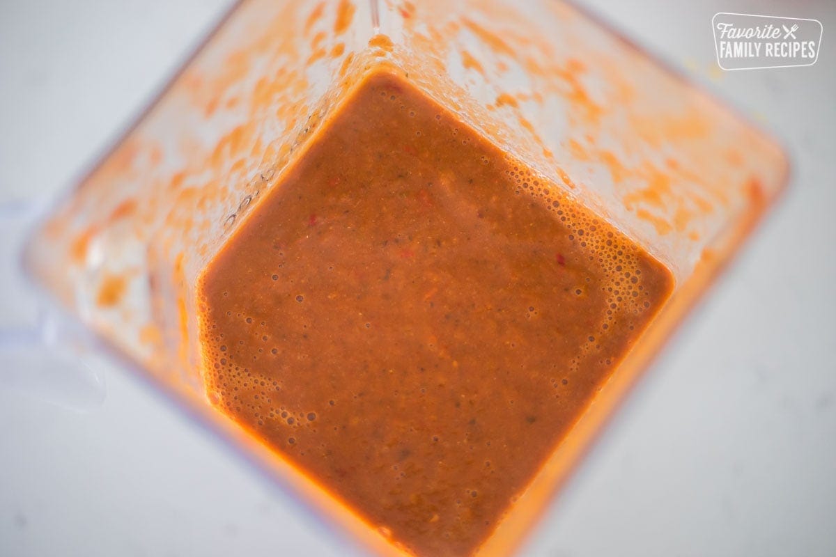 Red sauce in a blender that has been blended into a puree
