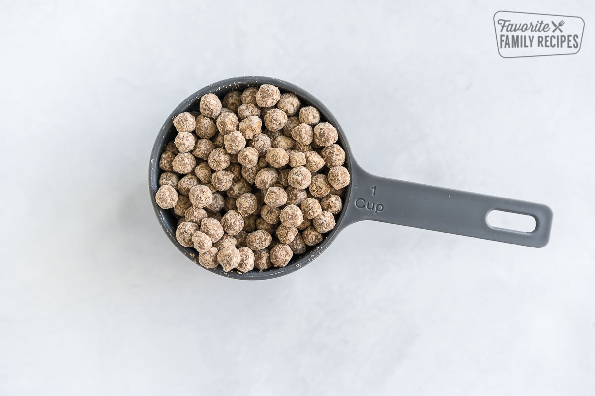 Uncooked tapioca pearls in a measuring cup.