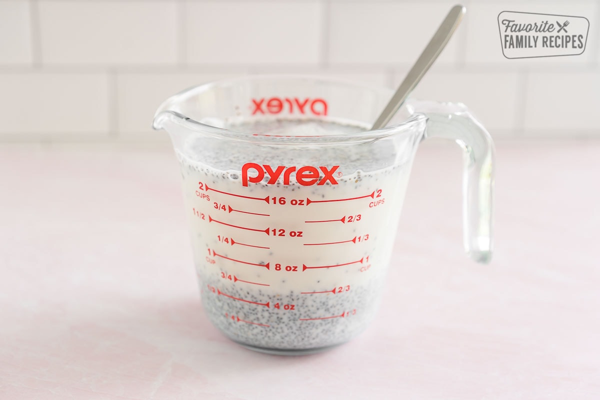 Chia seeds and milk in a glass measuring cup