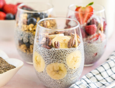 Three Chia Seed Pudding cups with fruit and nut toppings