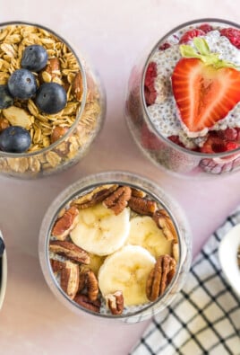 Three Chia Seed Pudding cups with fruit and nut toppings