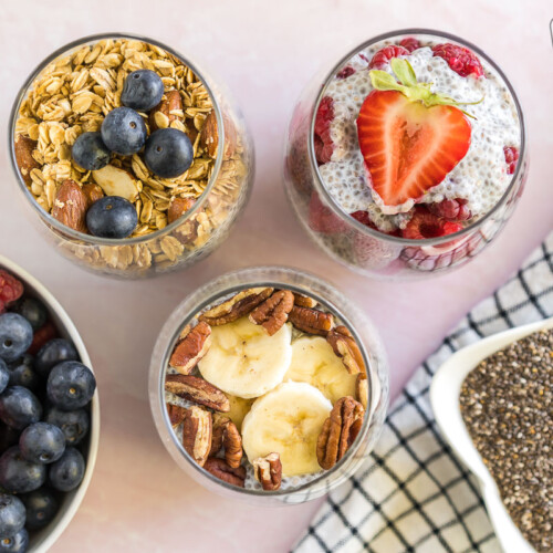 Three Chia Seed Pudding cups with fruit and nut toppings