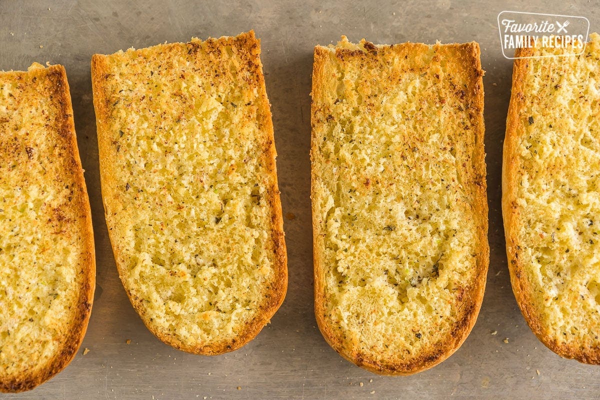 Four halves of cooked garlic bread
