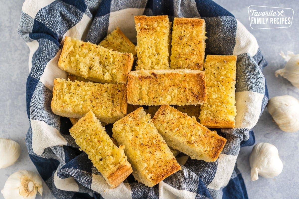 A basket full of sliced garlic bread.