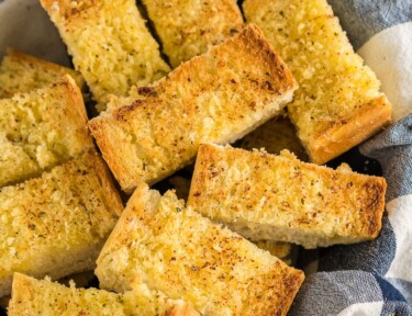 A basket full of sliced garlic bread