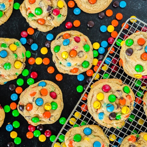 A dozen M&M cookies on a black background to show vibrant colors of candies