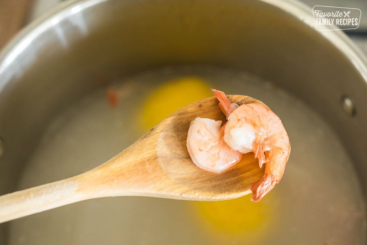 Two shrimp on a wooden spoon