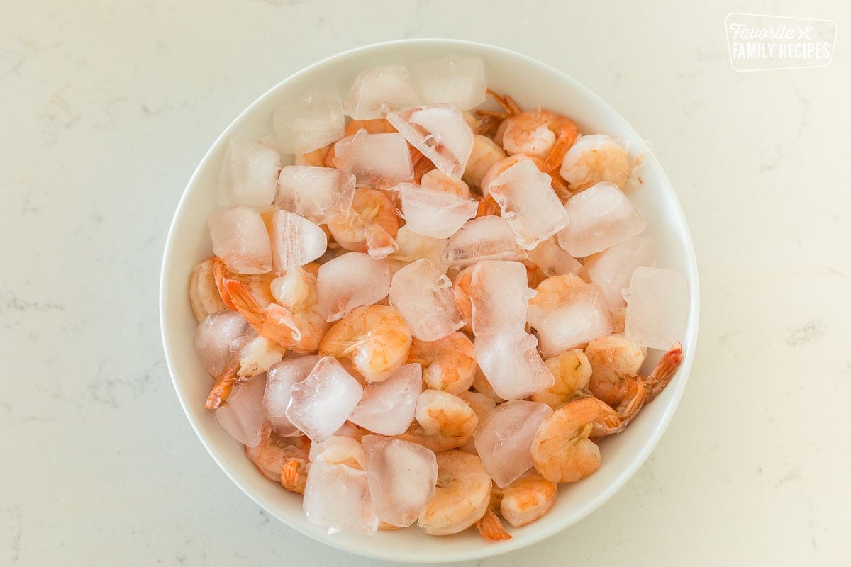 Cooked shrimp in a bowl with ice cubes