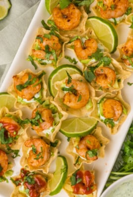 Plated shrimp taco bites with limes and cilantro
