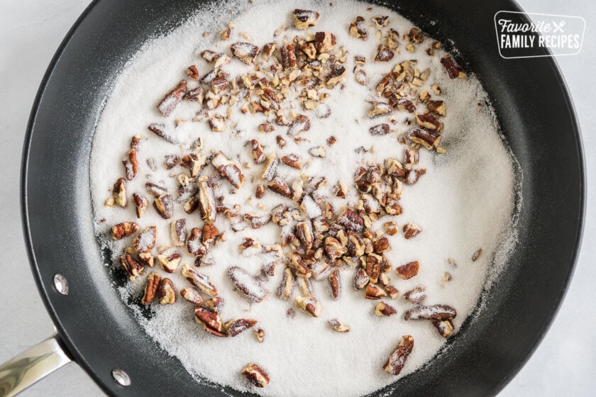 Pecans and white sugar in a skillet