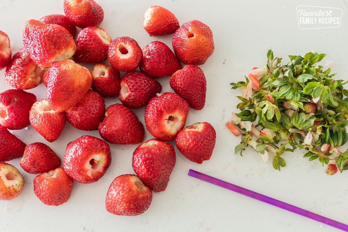 Hulled strawberries next to their stems