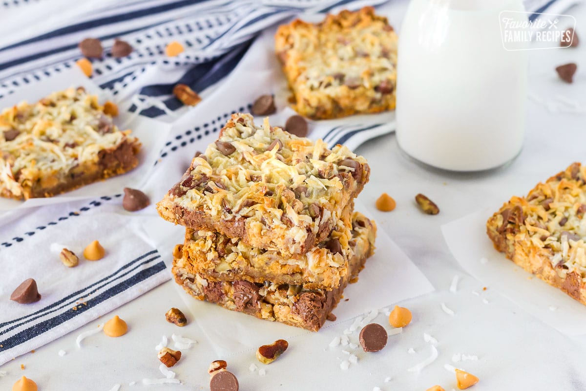 Stacked squares of 7 Layer Magic Cookie Bars.