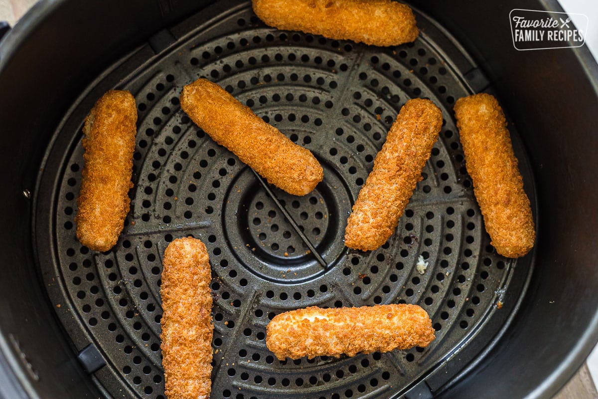 Mozzarella sticks in an air fryer basket