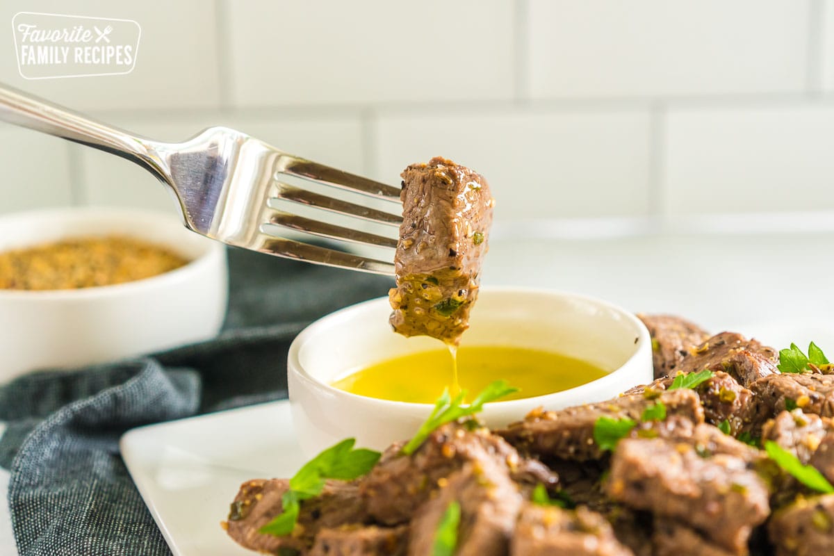 A steak bite dipped in butter.