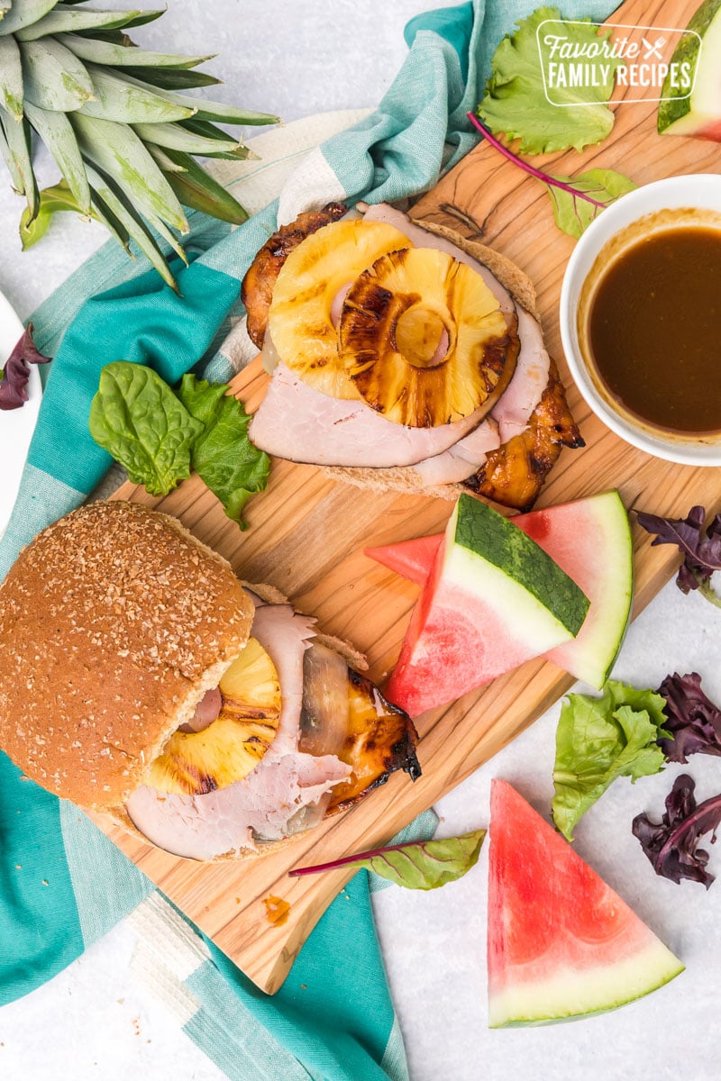 Big Kahuna Teriyaki Chicken Sandwiches on a wood board with watermelon