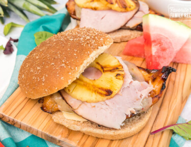 Big Kahuna Teriyaki Chicken Sandwiches on a wood board with watermelon