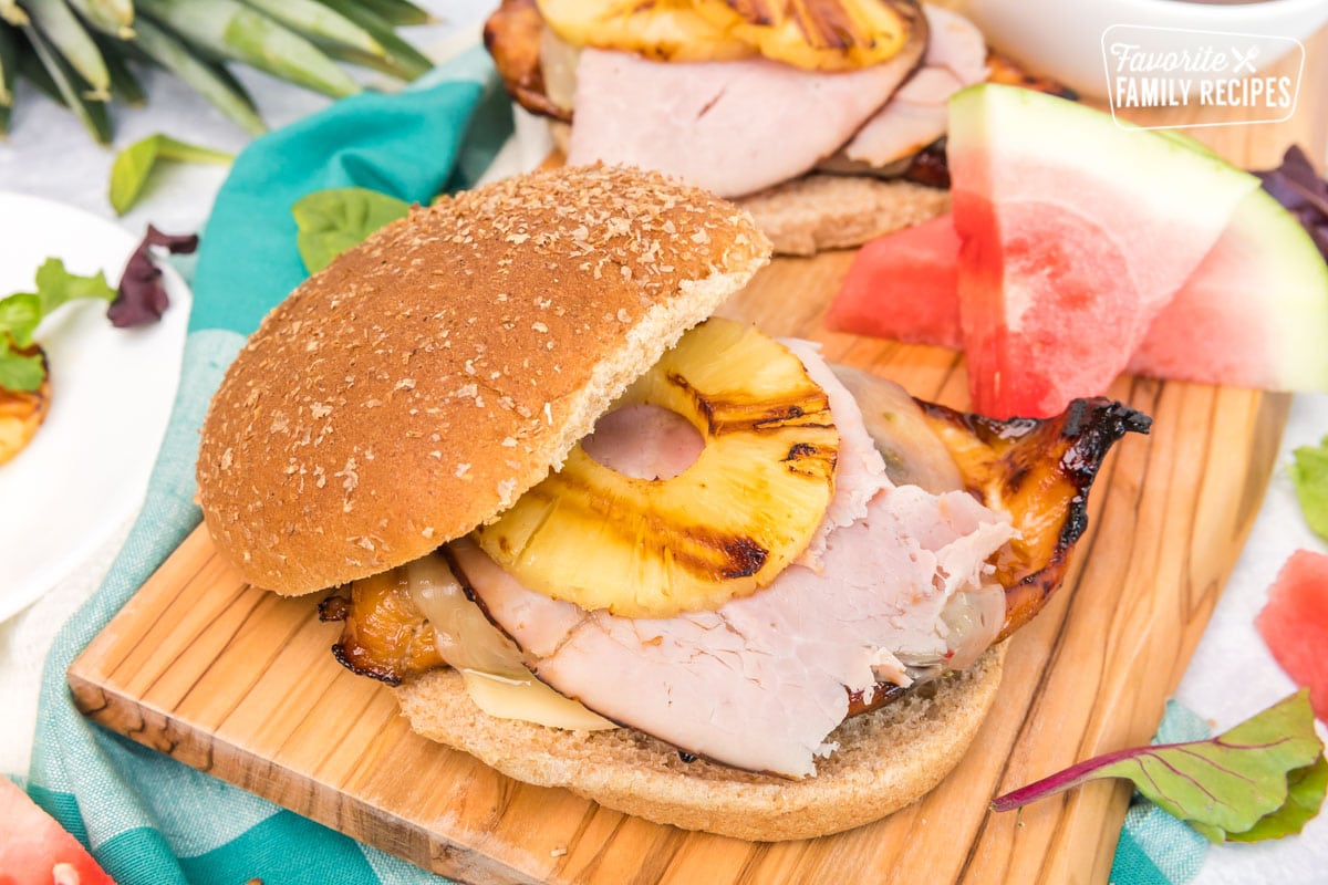 Big Kahuna Teriyaki Chicken Sandwiches on a wood board with watermelon