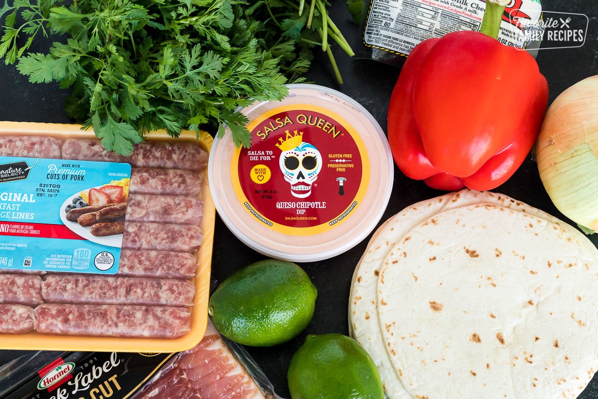 Ingredients to make breakfast tacos including sausage, bacon, tortillas, and chipotle sauce