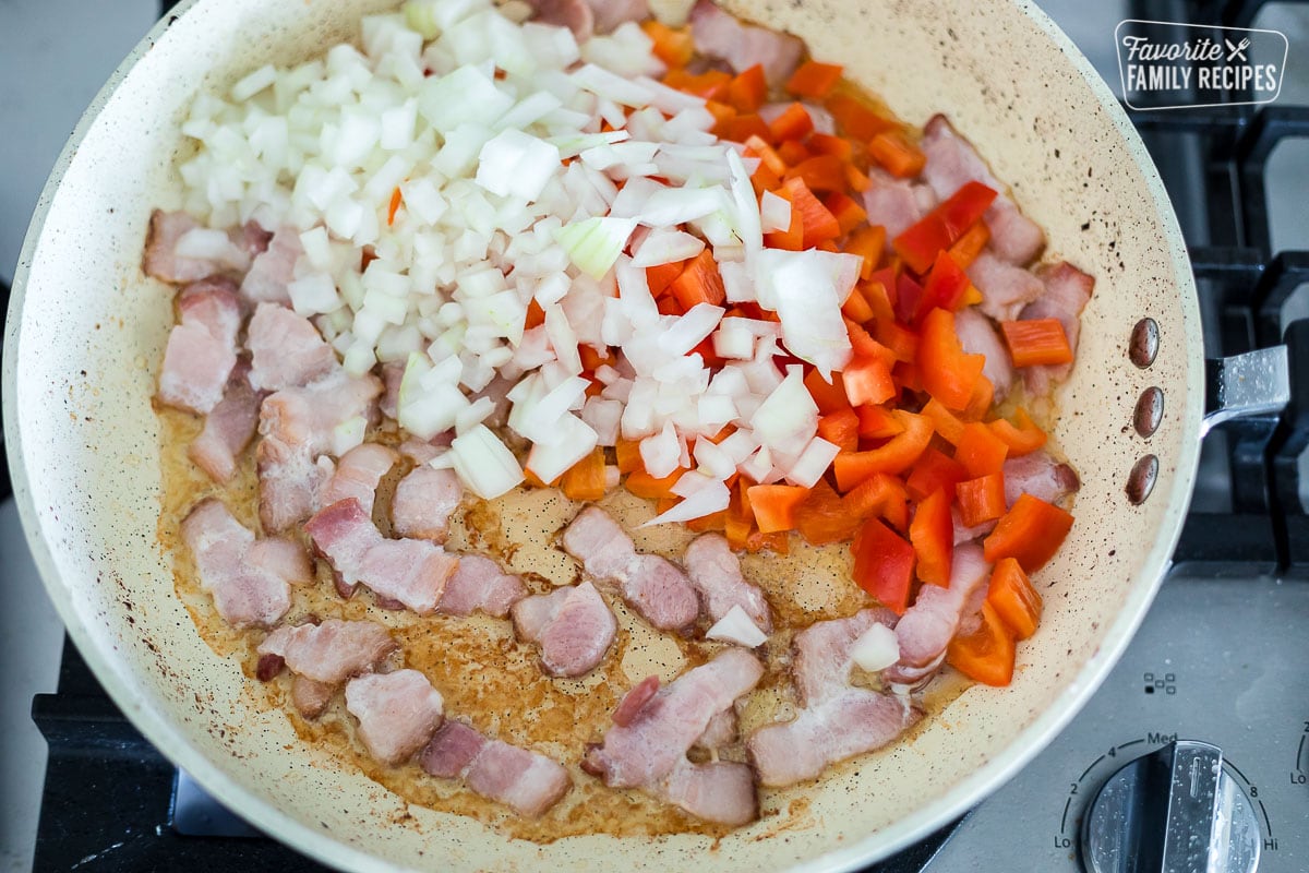A pan with peppers, onions, and bacon