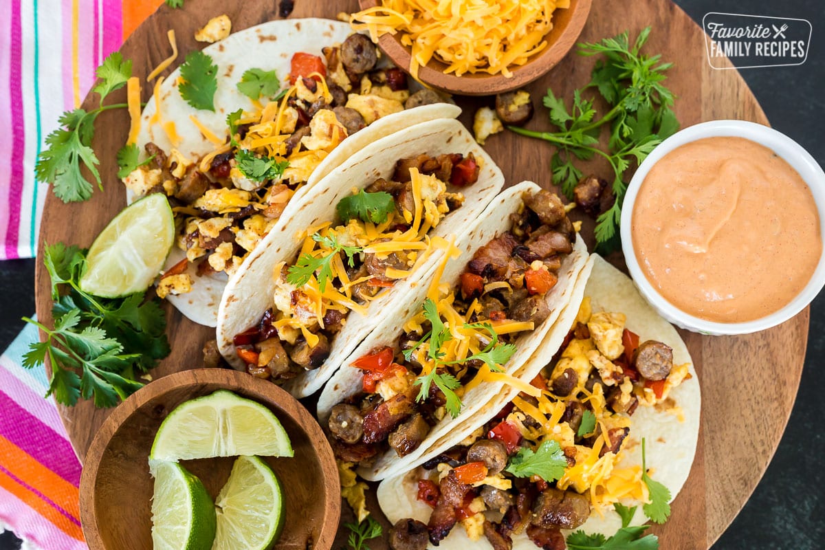 A top view of four breakfast tacos on a platter.