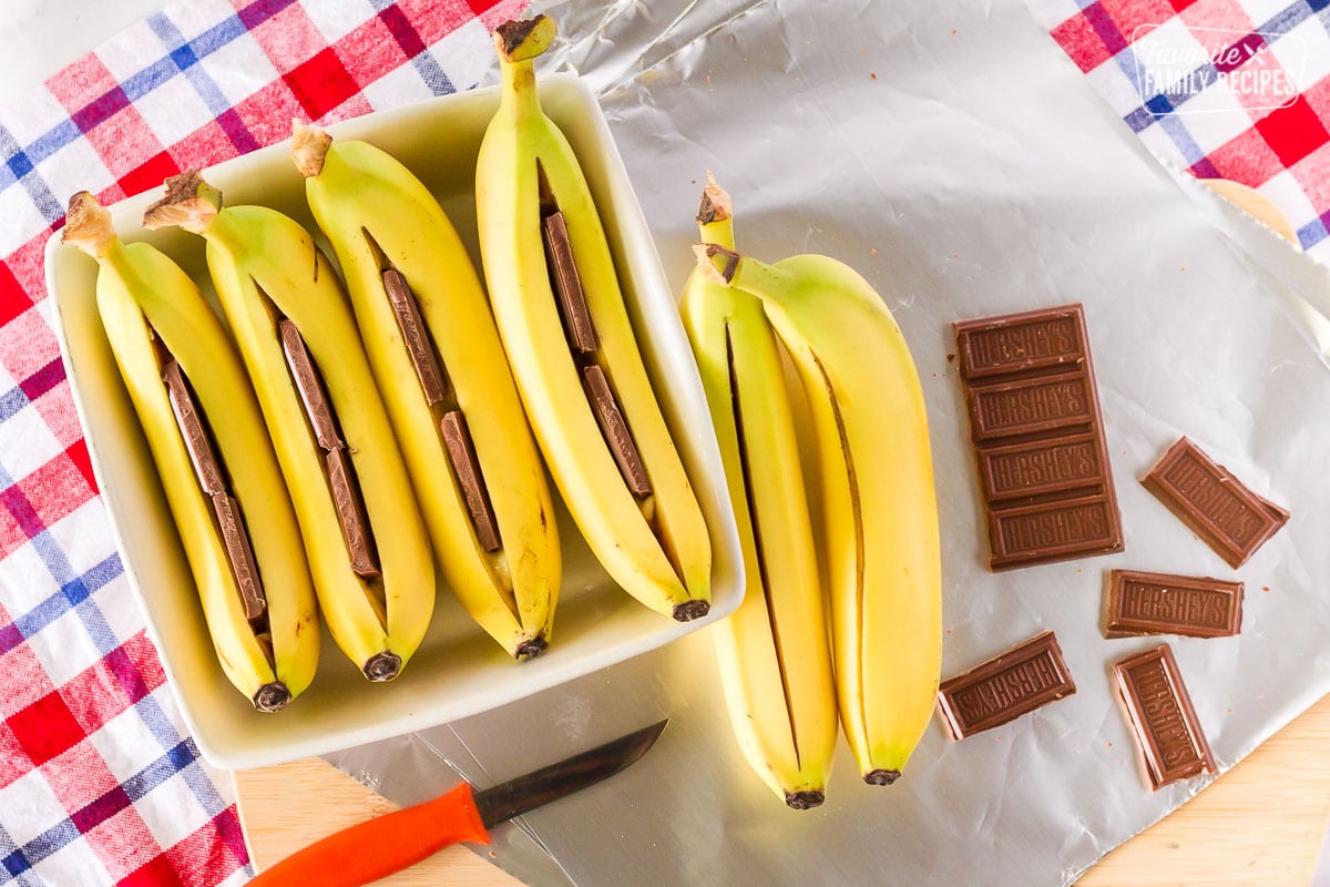 Chocolate bars pushed into banana to make campfire boats.