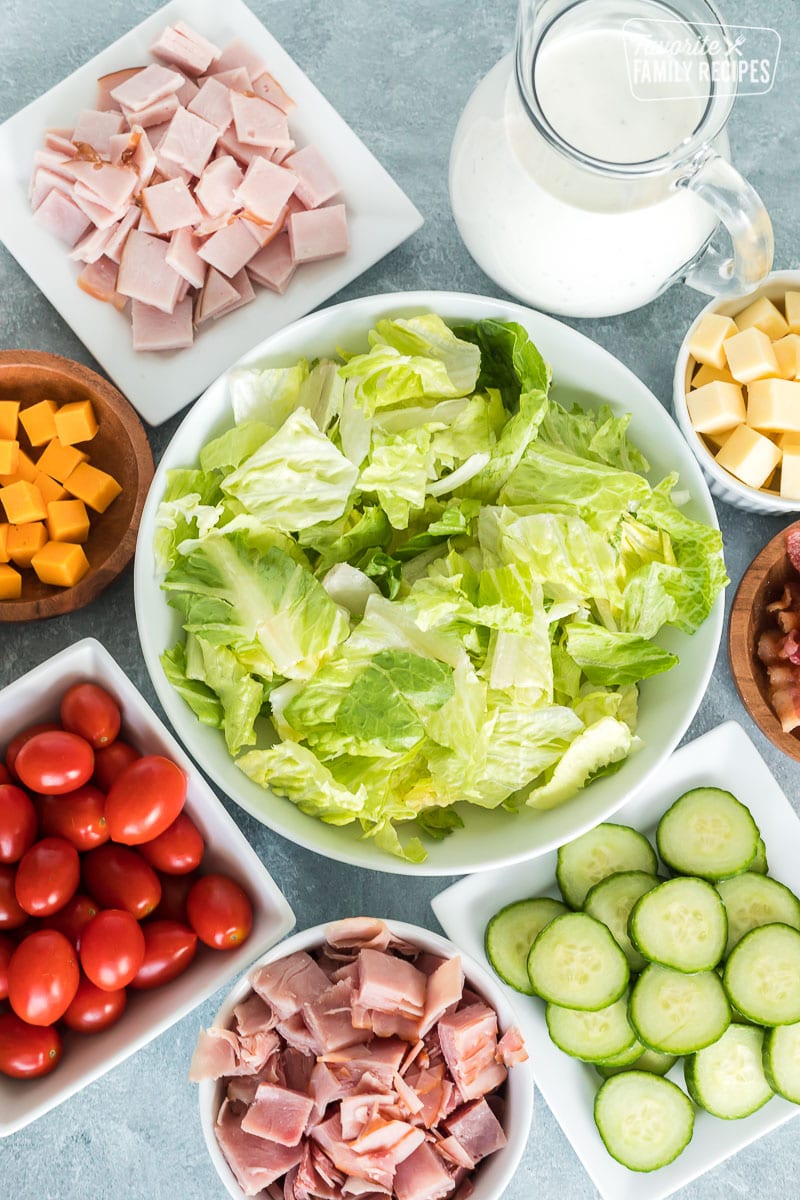 Lettuce, ham, cheese, cucumbers, ranch dressing and other ingredients to make a Chef Salad