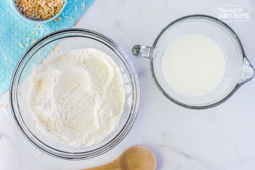 Bowls of flour and buttermilk mixtures for coconut cream cake.
