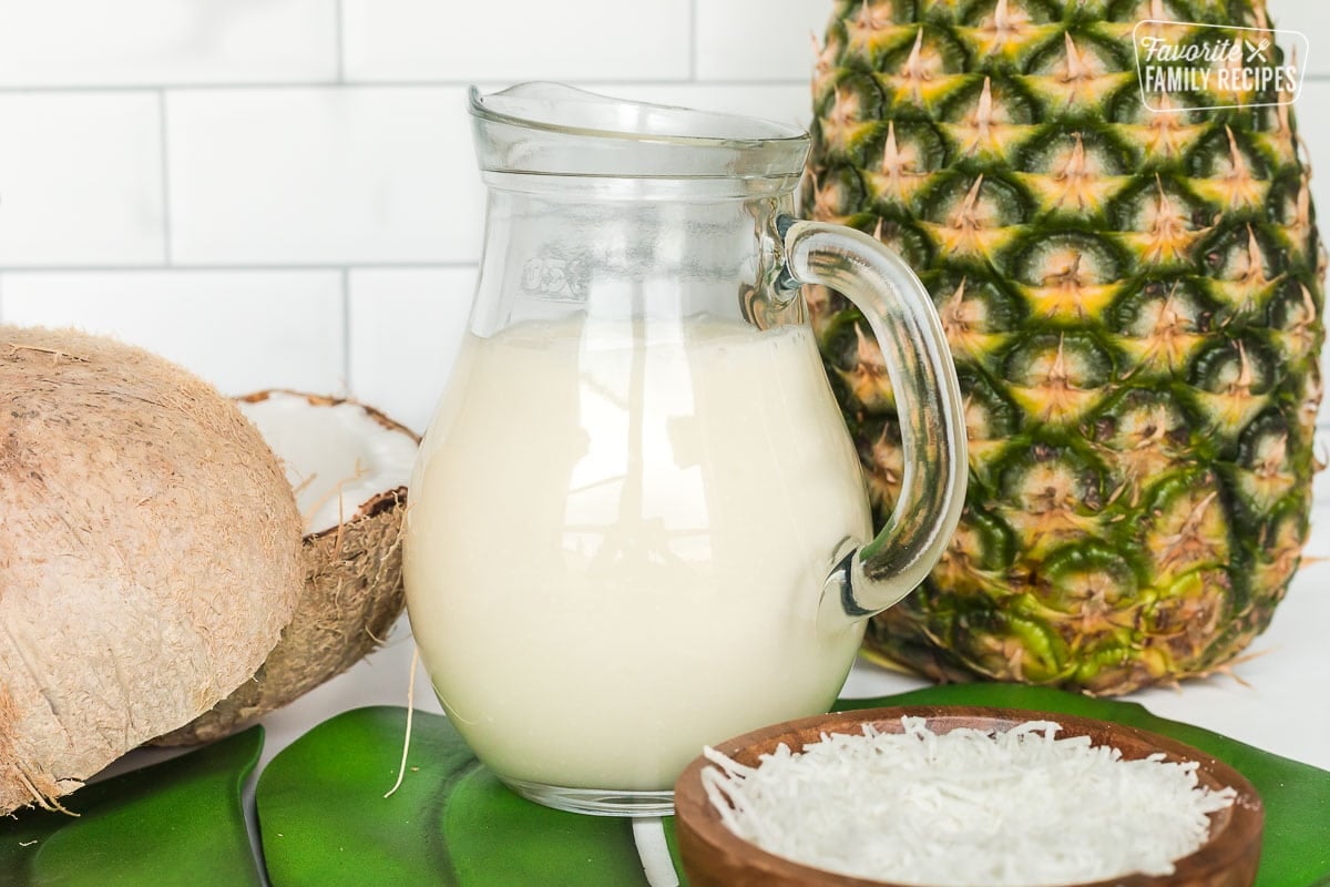 Side view of coconut syrup in a glass pitcher