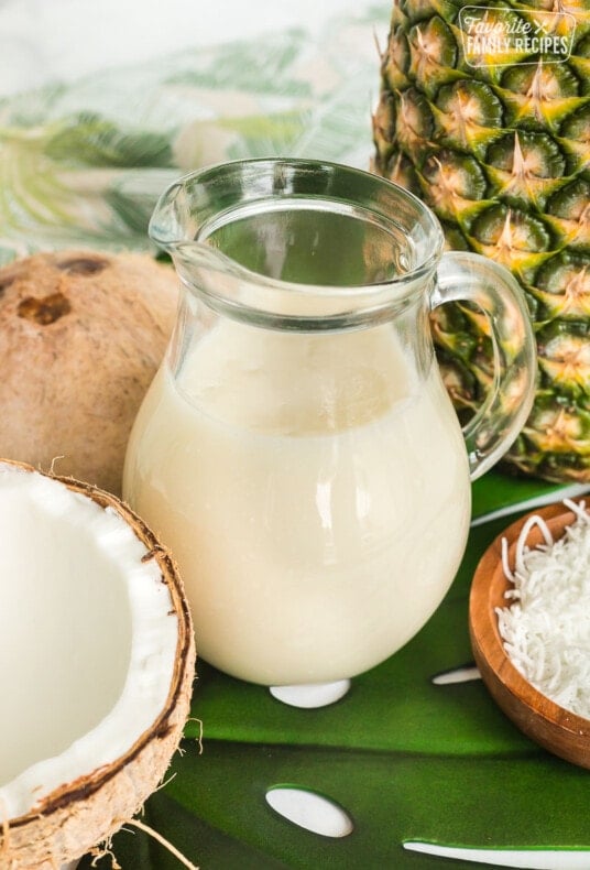 A clear, glass pitcher of coconut syrup