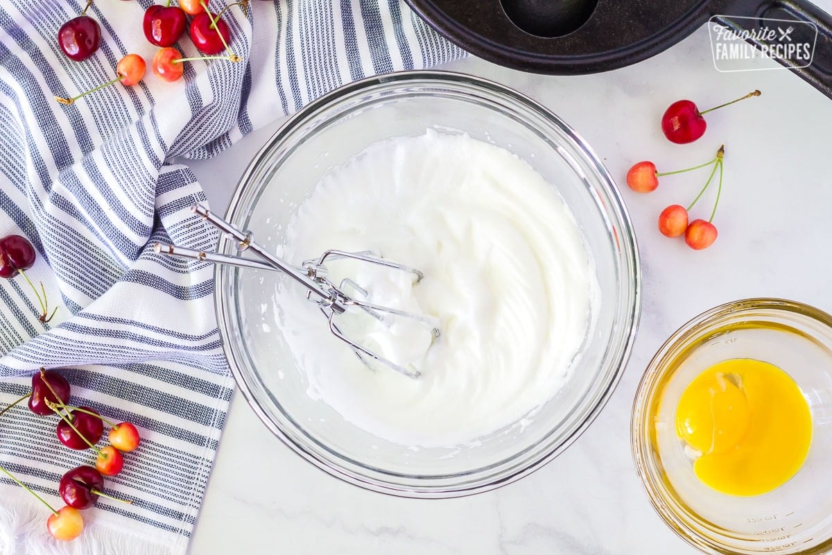 Whipped egg whites and yolks in separated bowls for Danish Aebleskiver.