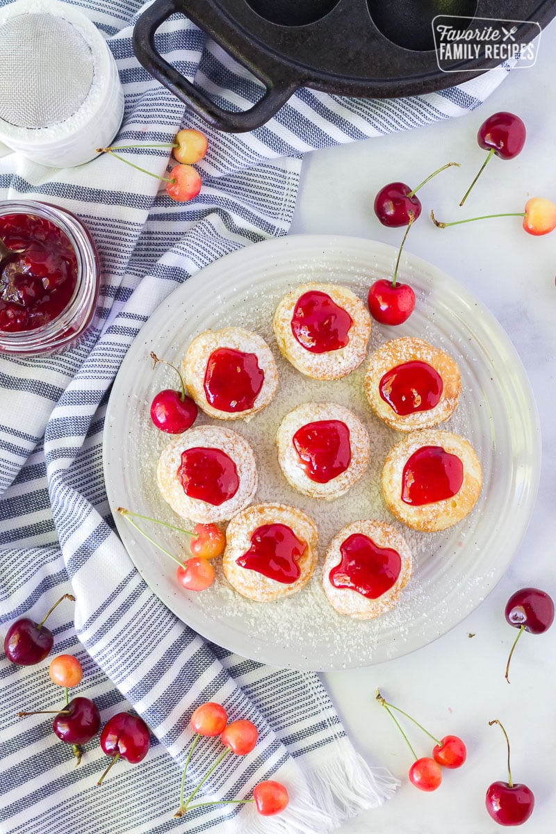 Top view of Danish Aebleskiver with cherries and a pan.