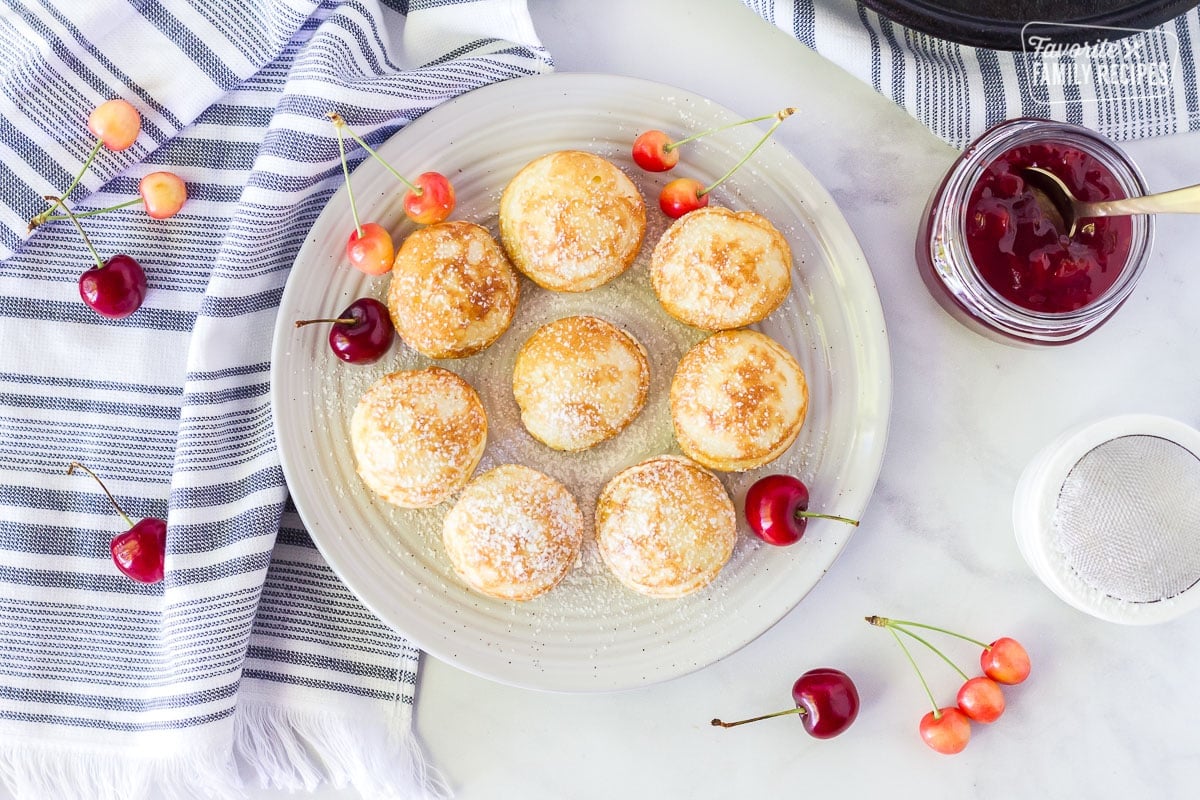 Plate of Danish Aebleskiver with powdered sugar.