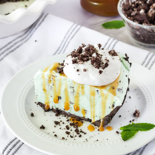 Slice of Grasshopper Pie with caramel and whipped topping.