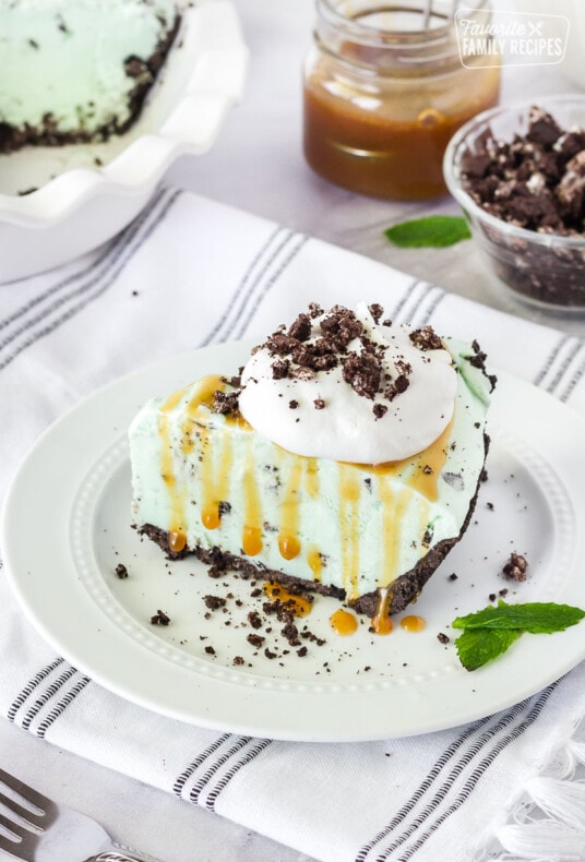 Slice of Grasshopper Pie with caramel and whipped topping.