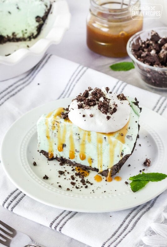 Slice of Grasshopper Pie with caramel and whipped topping.