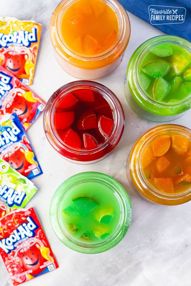 Tired of the same old popular picnic food? Then you should try Kool Aid Pickles! They’re a little sweet, a little tart, and a lot of fun to make and eat. A real adventure for your taste buds! Top View of Kool Aid Pickle Jars.