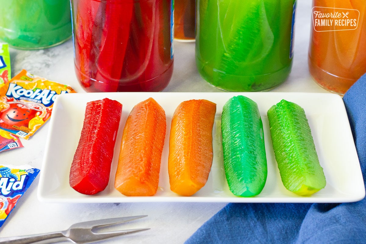 Tired of the same old popular picnic food? Then you should try Kool Aid Pickles! They’re a little sweet, a little tart, and a lot of fun to make and eat. A real adventure for your taste buds! Close up of Kool Aid Pickles.