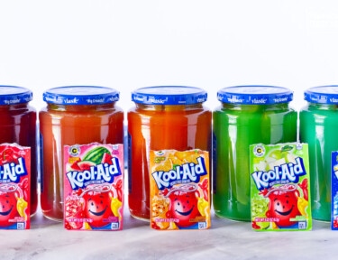 Colorful jars of Kool Aid Pickles.