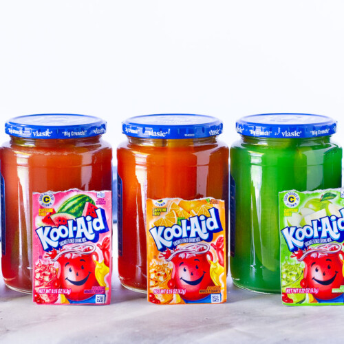 Colorful jars of Kool Aid Pickles.
