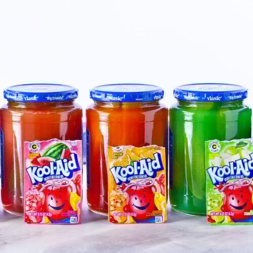 Colorful jars of Kool Aid Pickles.