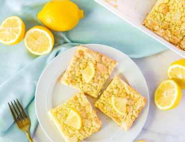 Three Lemon Cream Cheese Bars on a plate.