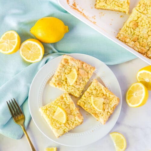 Three Lemon Cream Cheese Bars on a plate.