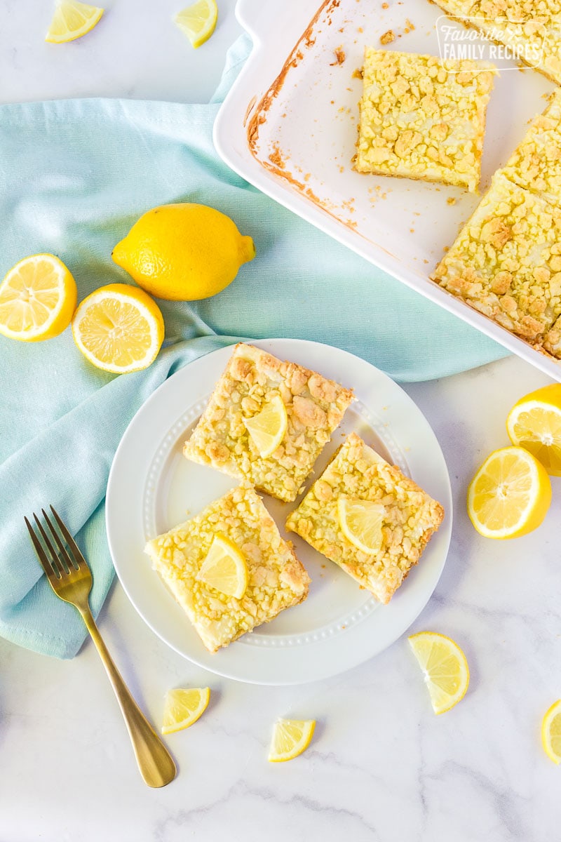 Three Lemon Cream Cheese Bars on a plate.