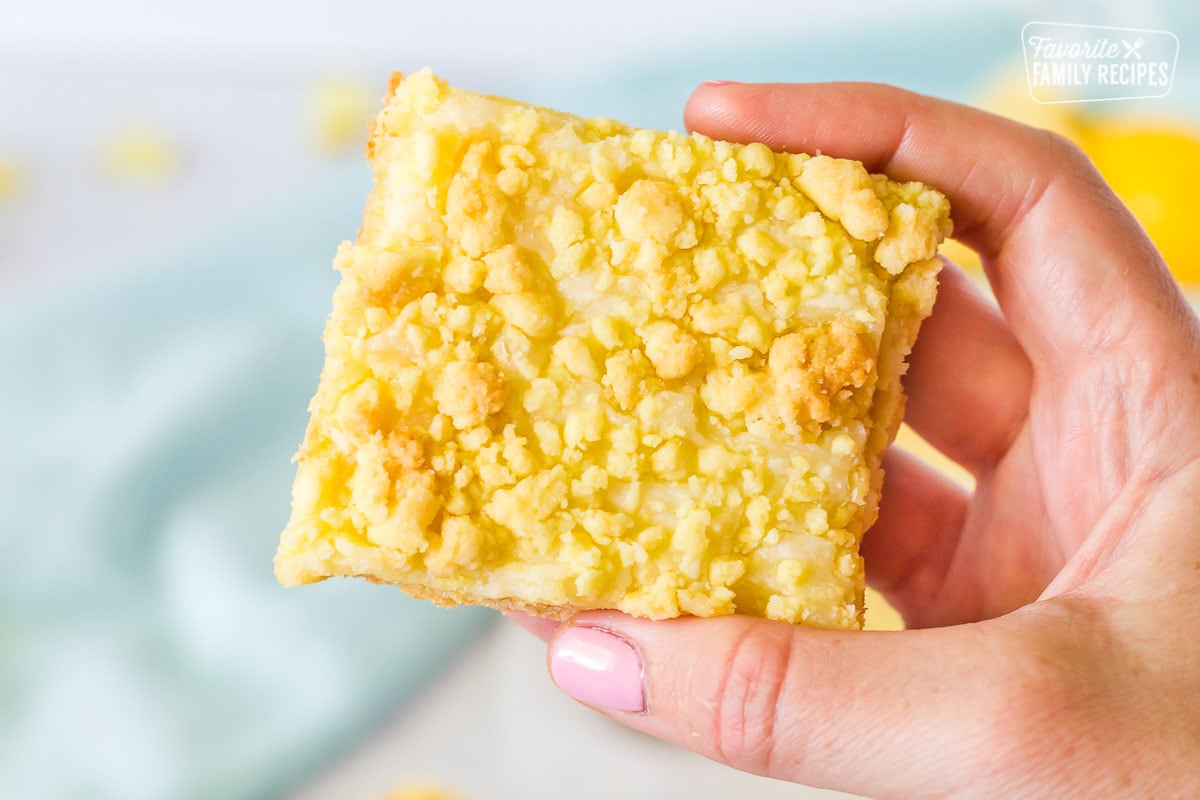 Hand holding up a Lemon Cream Cheese Bar.