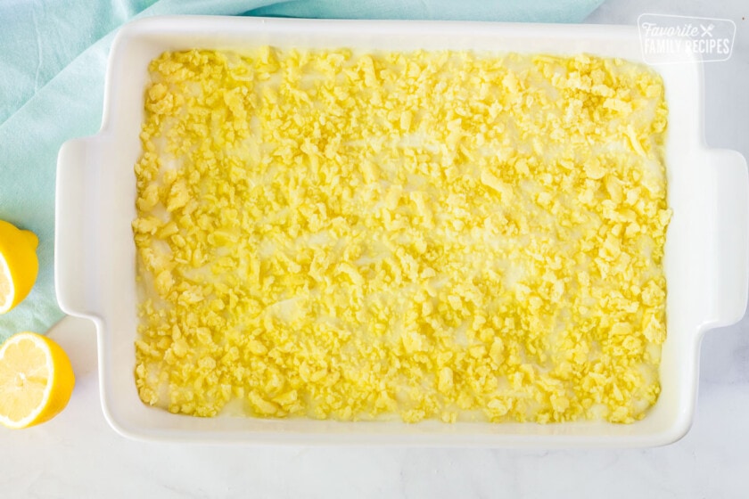 Unbaked crumble topping on a pan of Lemon Cream Cheese Bars.